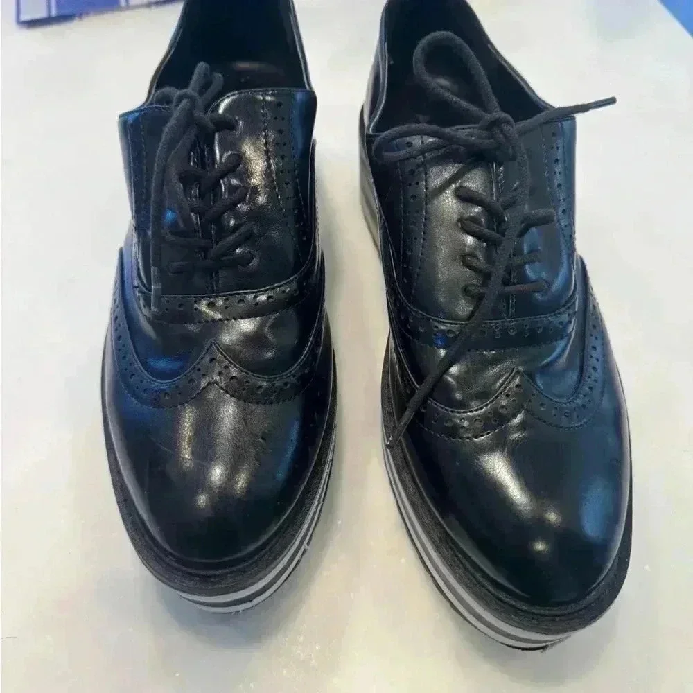 Aldo women’s platform leather wingtips / black & white sole size 9